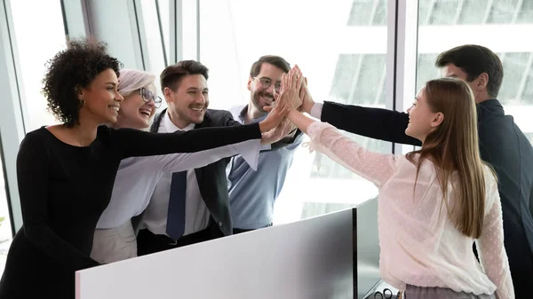 Overjoyed businesspeople give high five showing unity