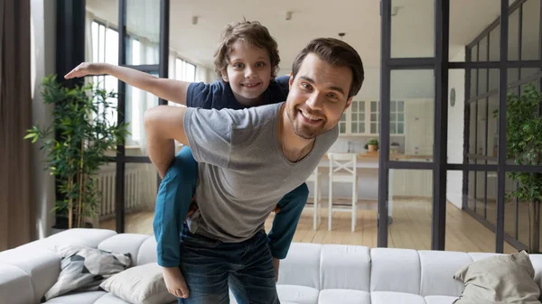 Overjoyed father and son playing together at home — Stock Photo, Image