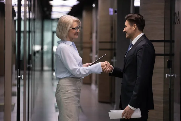 Stock image Smiling businesspeople shake hands greeting in office