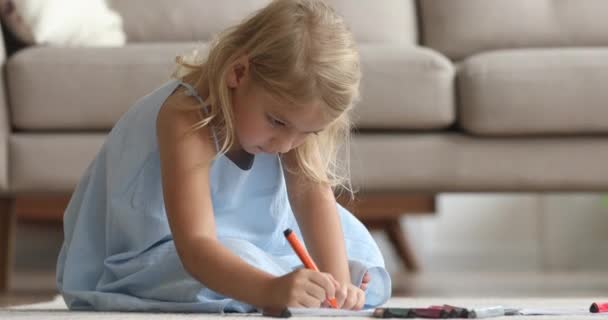 Focused adorable little preschool girl coloring pictures in album. — Stock Video