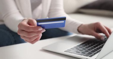Bilgisayarda ödeme yapan kredi kartı sahibi kadın müşteri, yakın plan.