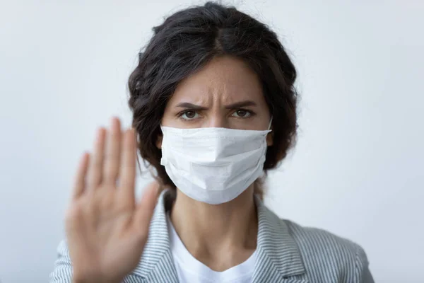 Woman in mask stretched arm as symbol of stop COVID19 — Stock Photo, Image