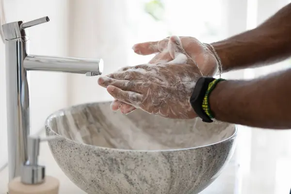Close up image african man cleans hands with soap — Stock Photo, Image
