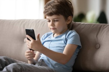 Anaokulu çocuğu evde akıllı telefon kullanıyor.