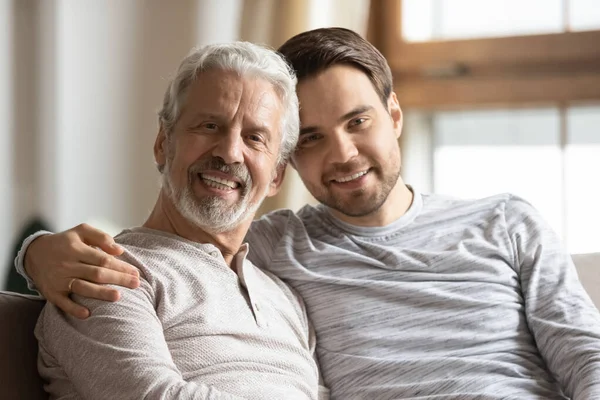 Portrait of elderly father and adult son hugging — Stock Photo, Image