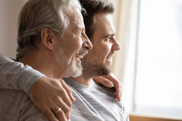 Elderly father and adult song look in distance dreaming — Stock Photo, Image