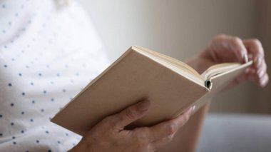 Kapatın kırışık elleri kağıt kitap tutarak.