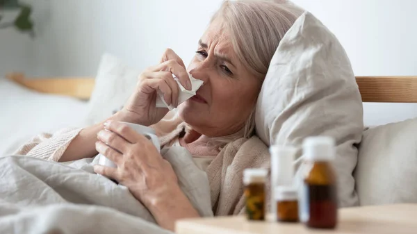 Head shot close up ill mature woman lying in bed. — Stock Photo, Image