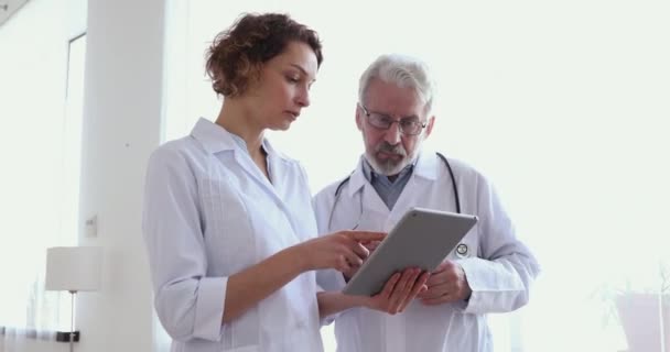 Equipo médico de dos médicos discutiendo usando tableta digital — Vídeos de Stock