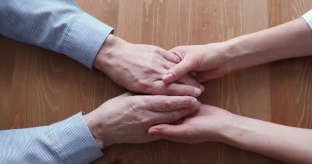 Young daughter or doctor holding old male hands, top view — Stock Video