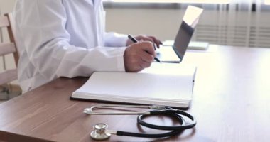 Masada steteskopla çalışan kıdemli doktorun yakın görüntüsü