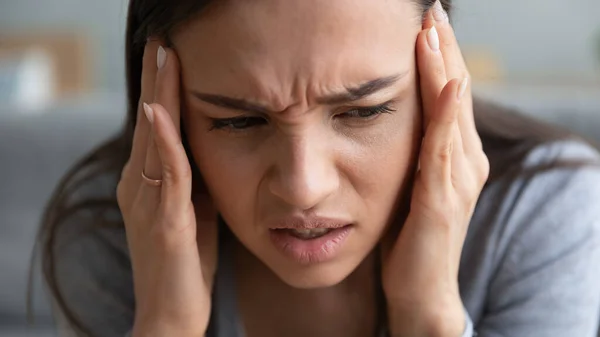 Unhealthy girl touch temples suffering from migraine — Stock Photo, Image