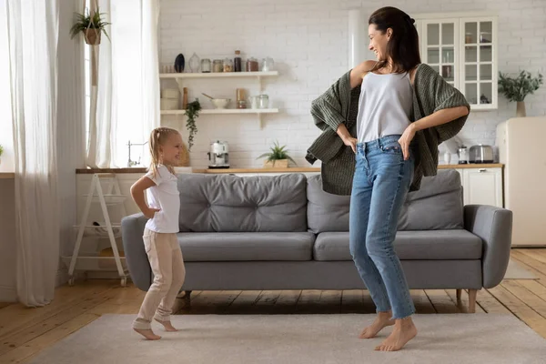 Happy young mom and small daughter dancing having fun — Stock Photo, Image
