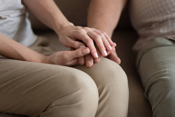 Middle-aged woman holding older man hands, expressing support — Stock Photo, Image