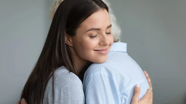 Happy millennial girl hug show love to elderly mother — Stock Photo, Image