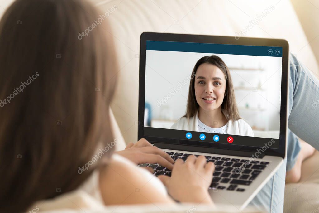 Attractive young woman chatting with female friend sister online.