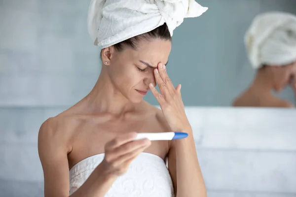 Woman holding pregnancy test see result feels desperation — Stock Photo, Image