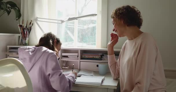 Happy mother helping teenage daughter doing homework giving high five — Stock Video