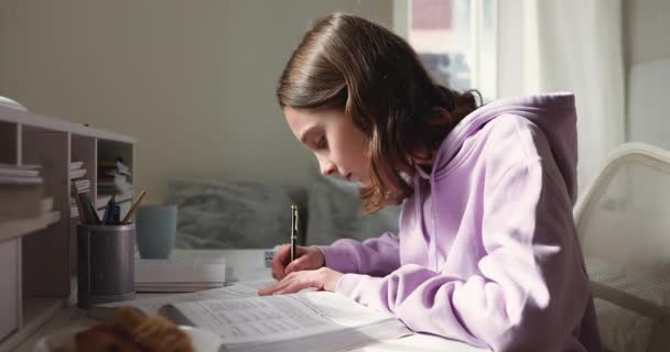 Teenager lernen, Lehrbücher lesen, Notizen am heimischen Schreibtisch machen — Stockvideo