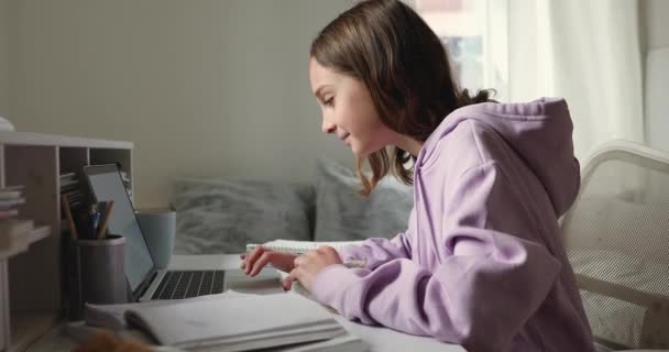 Happy teen playing with rat using laptop at home desk — Stock Video