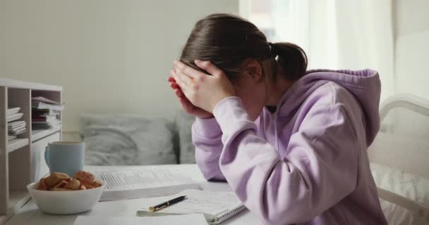 Exhausted upset school girl studying alone feeling headache at home — Stock Video