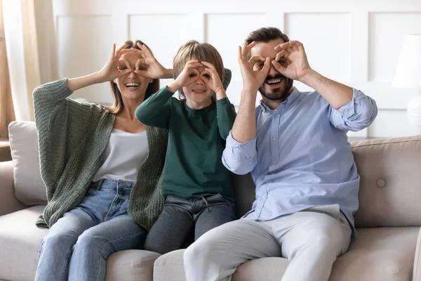 Overjoyed couple playing tricks fool with son at home. — Stock Photo, Image