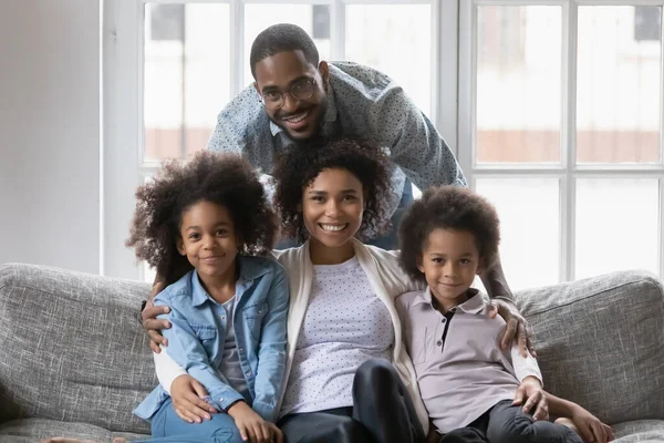 African ethnicity full family photo shooting seated on couch — Stock Photo, Image