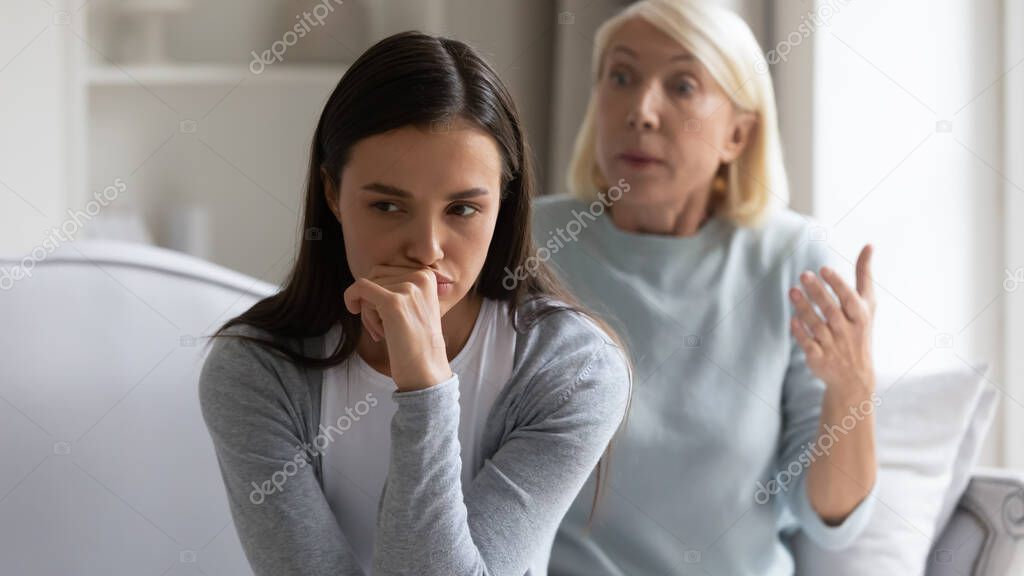 Angry adult daughter ignore authoritative senior mom scolding