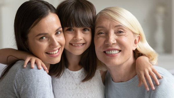 Portrait of smiling three generations of women hugging