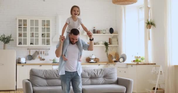 Loving dad carrying kid daughter giving piggyback ride at home — Stock Video