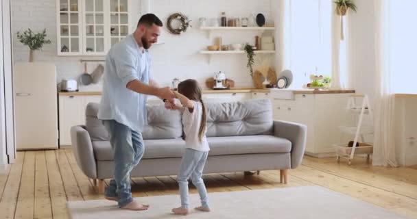 Счастливый отец и милая дочка танцуют на кухне — стоковое видео