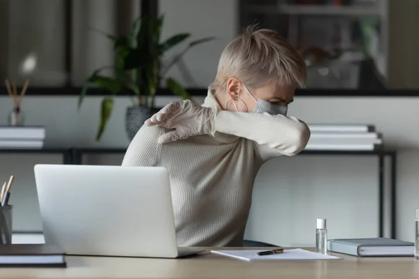 Unhealthy 30s female worker employee coughing in elbow. — Stock Photo, Image