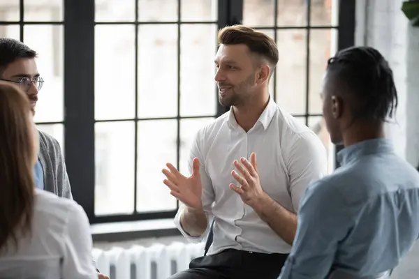 Happy male psychologist counselling speaking with diverse people. — Stock Photo, Image