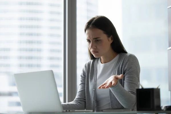 Frustrated female employee having computer problems at workplace