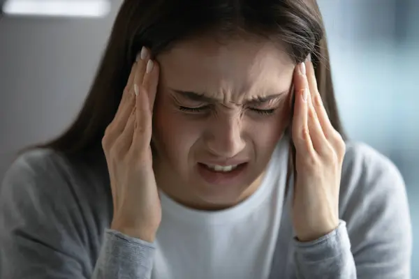 Unwell young woman suffer from migraine at workplace — Stock Photo, Image