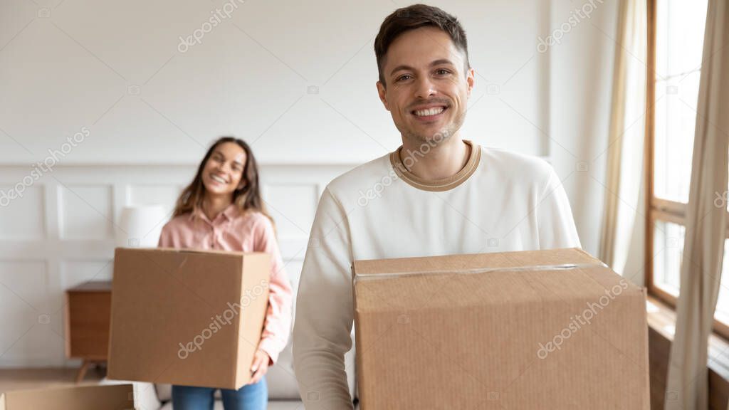 Smiling family couple moving in new apartment.