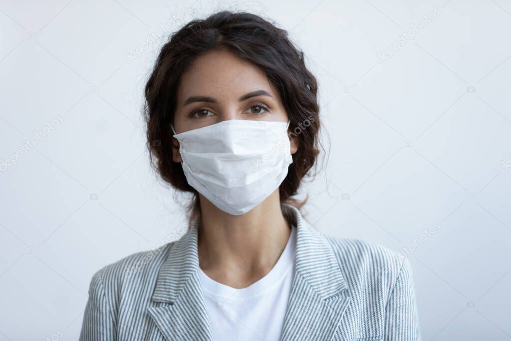 Portrait of young beautiful woman wearing medical protection respirator mask.