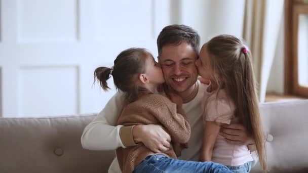 Niedliche kleine Kinder Mädchen umarmen küssenden lächelnden Vater. — Stockvideo