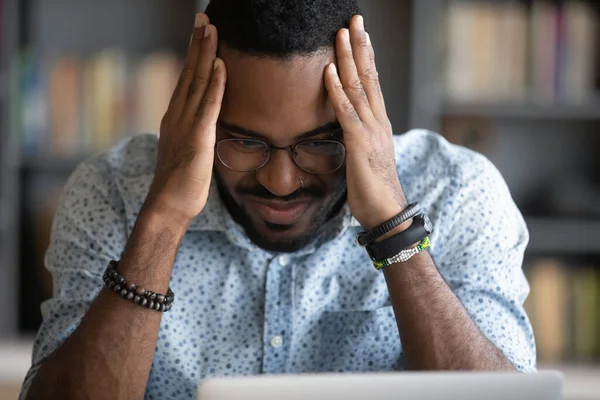 Depressed worried african ethnicity guy feeling anxious.