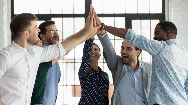 Overjoyed diverse colleagues give high five celebrating success — Stock Photo, Image