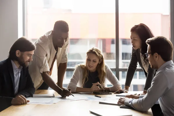 Multiracial colleagues discuss financial paperwork at meeting — Stock Photo, Image