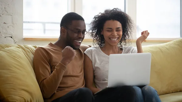 Feliz pareja afroamericana joven mirando portátil . —  Fotos de Stock