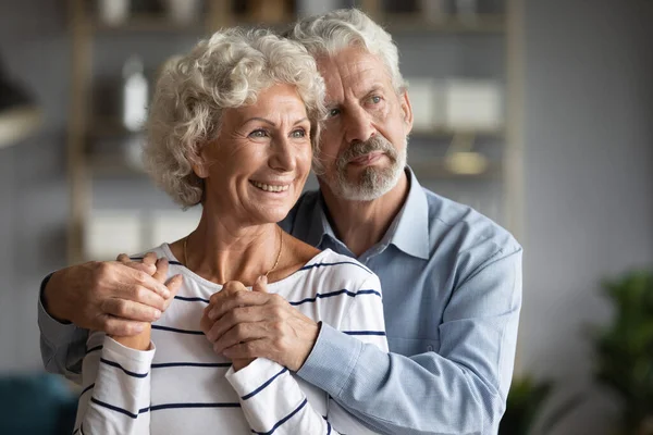 Happy older couple hugging, dreaming about good future together — Stock Photo, Image