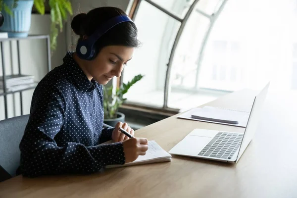Female employee in earphones have web conference with coworkers — Stock Photo, Image