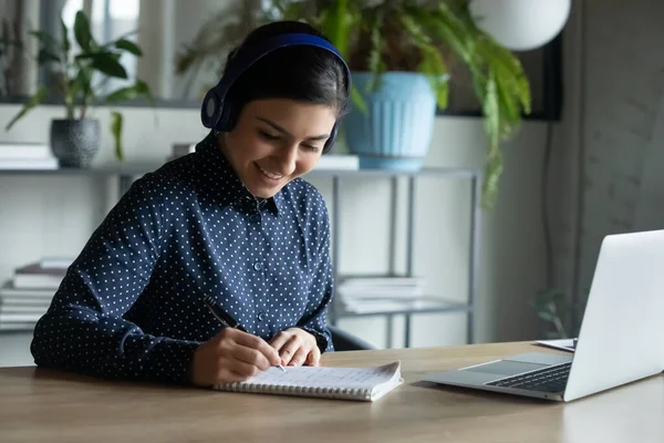 Smiling female in headphones talk on video call — Stock Photo, Image