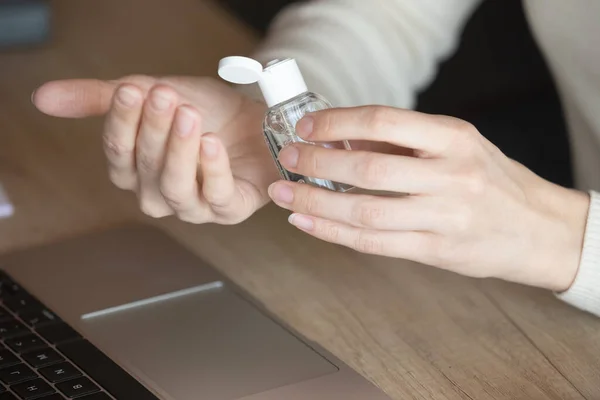 Close up of female employee cleanse hands with sanitizer — Stock Photo, Image