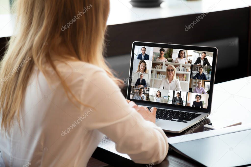 Businesspeople communicating using application webcam laptop view over businesswoman shoulder