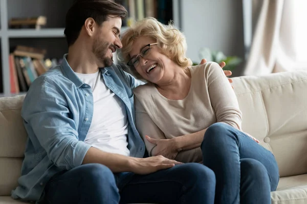 stock image Cheerful mature mother enjoy communications laughs talks with adult son