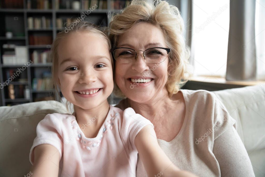 Grandmother and granddaughter having fun with smartphone making selfie picture