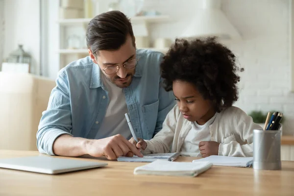 Caring dad help biracial daughter with homework at home — Stock Photo, Image